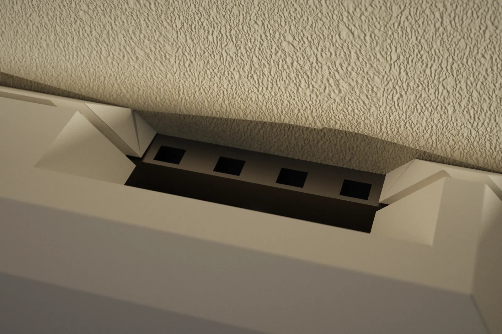 Close view of the port in the top of the case, with the thermostat plate's edge visible inside.
